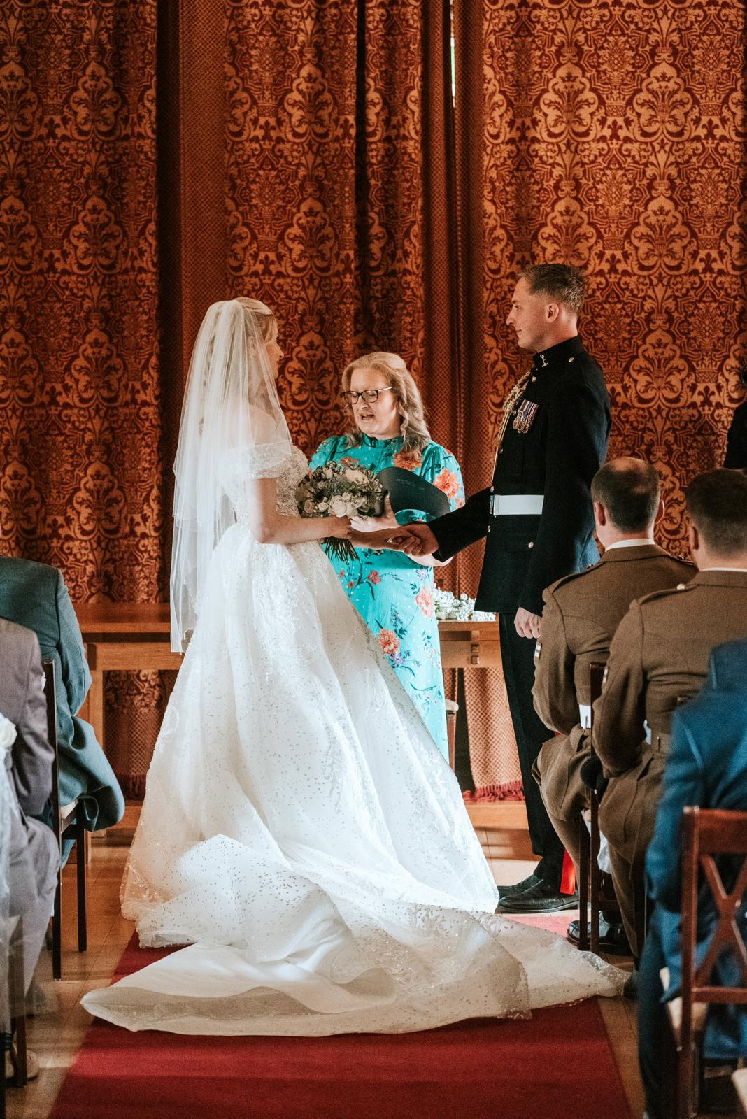 Deb Reed Celebrant Colchester Essex, officiating at the wedding of Cheyney and Albert during their first kiss.